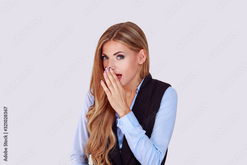 Gossiping. Excited one woman telling news gossip a secret holding hand near mouth whisper secrecy gesture. Isolated light purple violet white background wall. Gossiping. Excited one woman telling news gossip a secret holding hand near mouth whisper secrecy gesture. Isolated light purple violet white background wall.