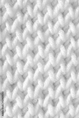Handmade knitting texture, white background. Gray wool with fine threads, close-up. © Nadzeya Pakhomava