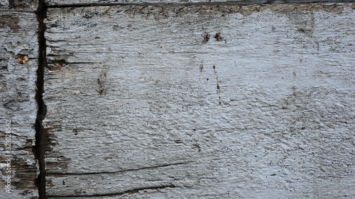 The white wooden planks of the house which have started to decay and have holes, Grunge colour