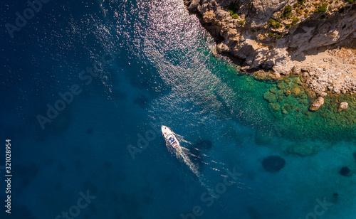 Aerial view on the boat sailing at sea. Summer vacation concept.