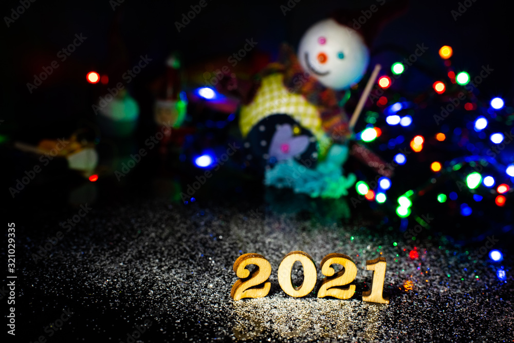 Fototapeta premium Happy New Year 2021. Symbol from number on wooden background.