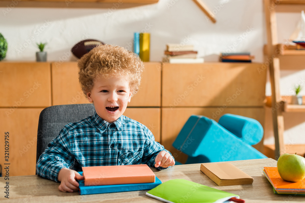 happy smart kid smiling near books and apple happy smart kid smiling near books and apple
