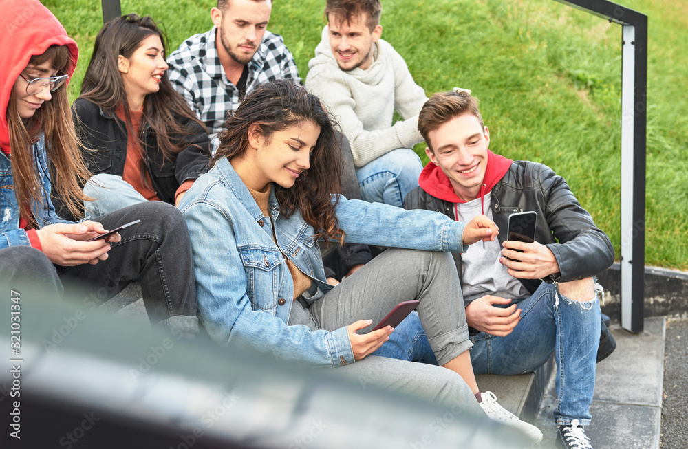 Fototapeta premium Young people having fun with mobile phone