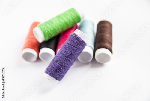 colorful spools of thread close-up on a white background