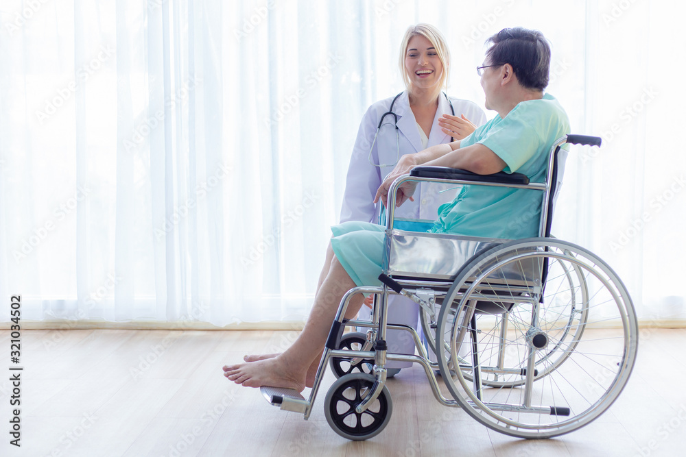 Nurse reassuring her patient on wheelchair in hospital / healthcare medical concept. copy space Nurse reassuring her patient on wheelchair in hospital / healthcare medical concept. copy space