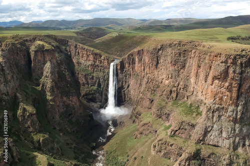 horizontal shot of stunning waterfall running down a steap canyon