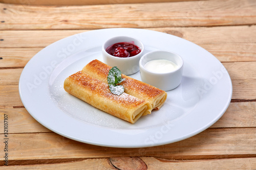 pancakes with sour cream and berry sauce