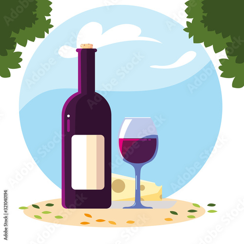 bottle and glass of wine with piece of cheese