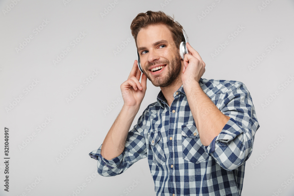 Portrait of happy young man using headphones and smiling Portrait of happy young man using headphones and smiling