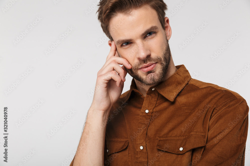 Portrait of unshaven young man posing and looking at camera