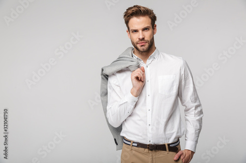 Portrait of confident young man posing on camera with jacket photo