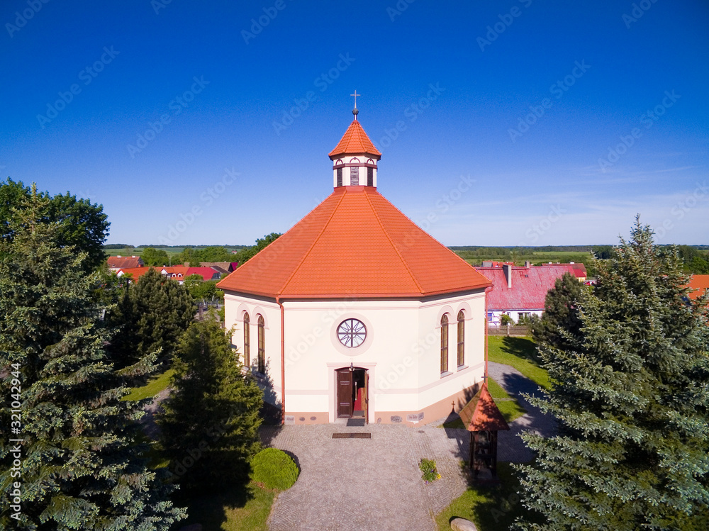 Aerial view of octagonal shaped Christ the King Church in Radzieje, Poland (former Rosengarten, East Prussia)