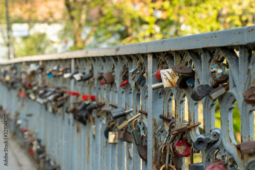 River bridge and locks - endless love symbol. Romantic artistic district Uzupis, Vilnius downtown, Lithuania.