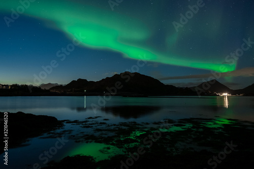 Northern lights in norway. Sea with reflection on aurora borealis © Jiri