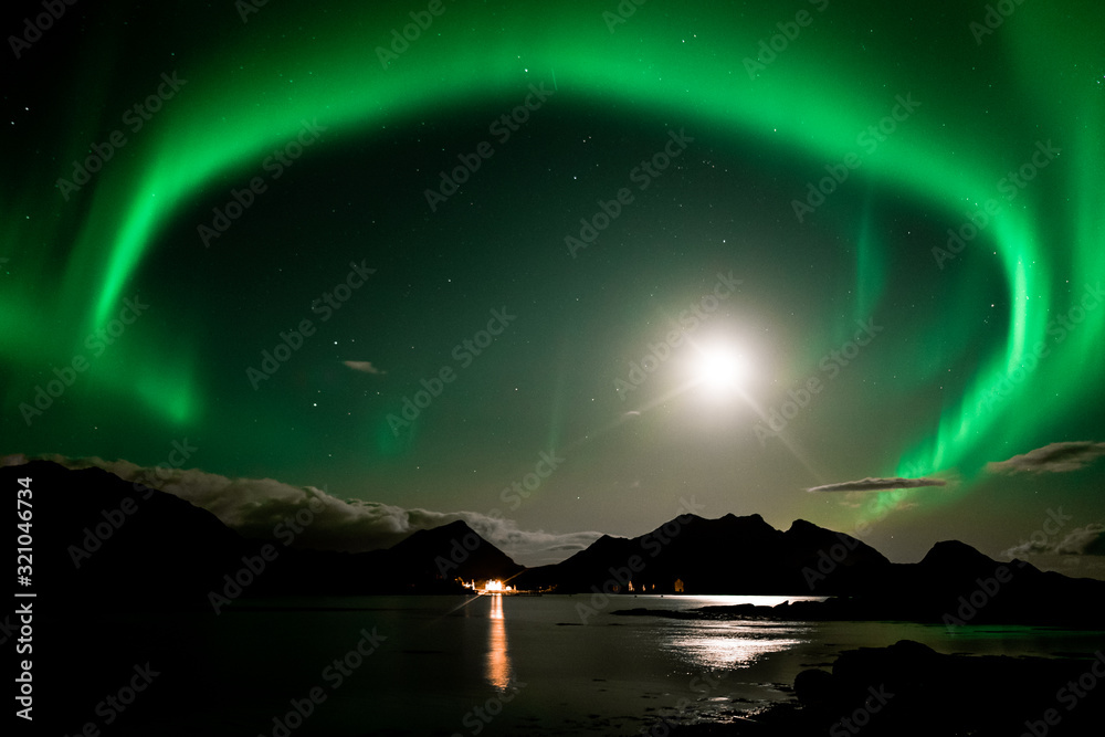 Northern lights in norway. Sea with reflection on aurora borealis