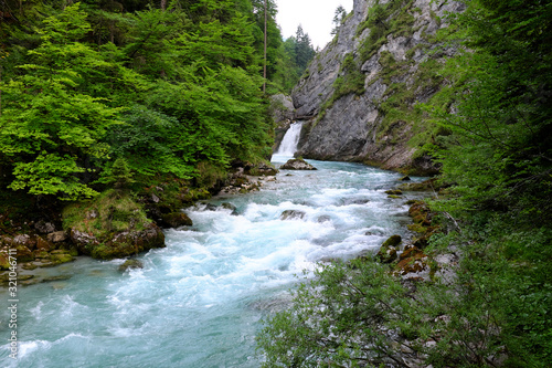 Wild Austrian river called Steyr and in the background waterfall called Stromboding.