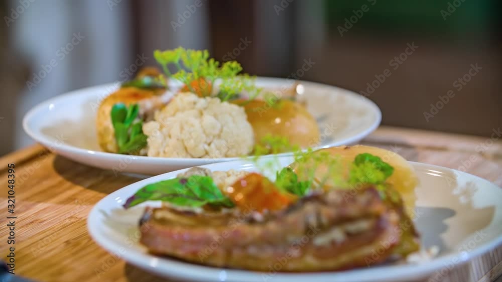 Close up shot of two typical Slovenian Blacksmiths dishes garnished with herbs. Focus rack