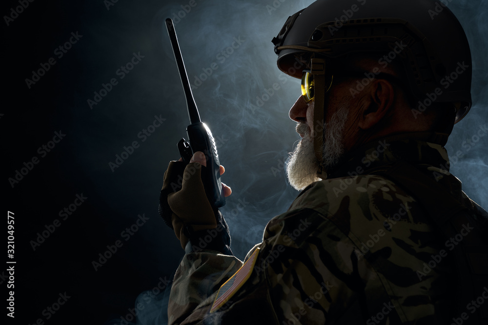 Military officer holding radio station. Military officer holding radio station.