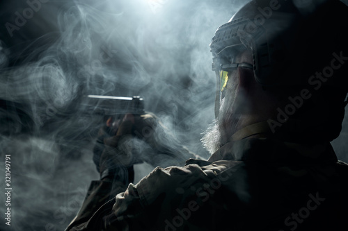Military veteran pointing with gun. © serhiibobyk