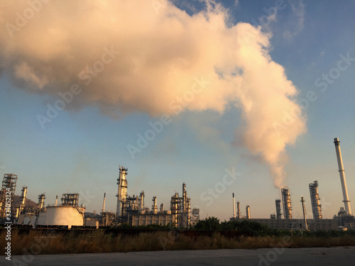Aerial view of chemical oil refinery plant, power plant on blue sky background.