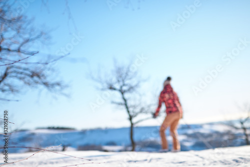 A skier rides on a mountain skiing on a winter morning. blurred background