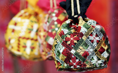  Closeup of Indian woman fancy hand bags or purses ,handmade in display of a shop