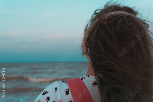 Happy girl enjoys the sunset