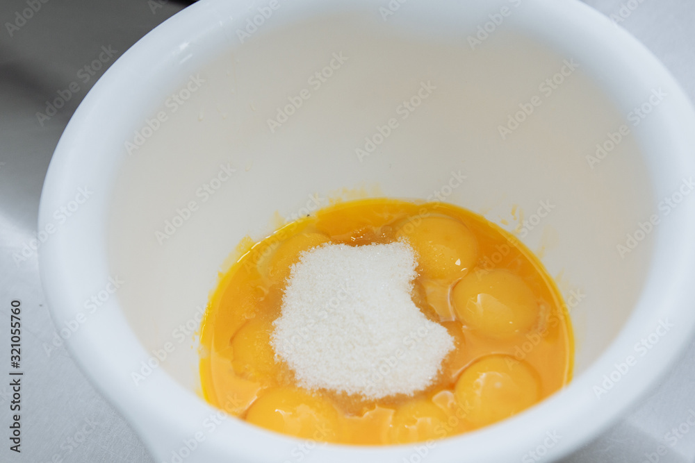 Egg yolks with proteins in a white plate are waiting for cooking Egg yolks with proteins in a white plate are waiting for cooking