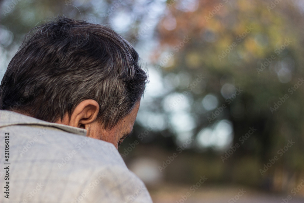 Senior man walking and relaxing in park. Walking away, relaxing, rear view Senior man walking and relaxing in park. Walking away, relaxing, rear view