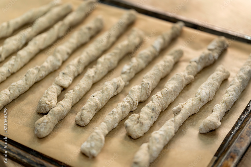 Crispy rye sticks sprinkled with flour. Rustic, laid out on a baking sheet. Crispy rye sticks sprinkled with flour. Rustic, laid out on a baking sheet.