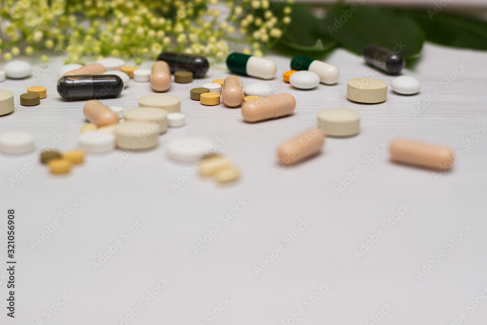 Medications, tablets and pill bottles with green herb Medications, tablets and pill bottles with green herb