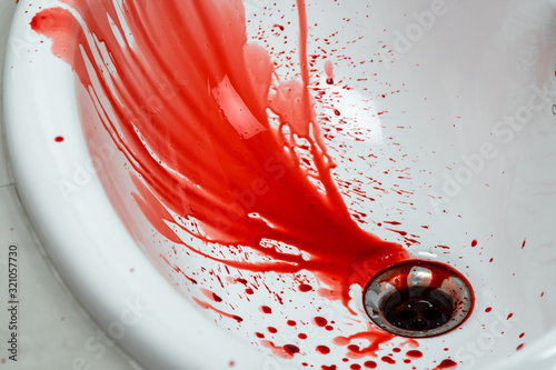 Closeup shot of blood dripping into sink..