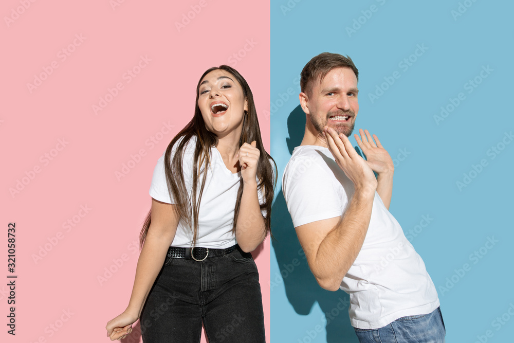 Crazy. Dancing, moving, having fun. Young and happy man and woman in casual clothes on pink, blue bicolored background. Concept of human emotions, facial expession, relations, ad. Beautiful couple. Crazy. Dancing, moving, having fun. Young and happy man and woman in casual clothes on pink, blue bicolored background. Concept of human emotions, facial expession, relations, ad. Beautiful couple.
