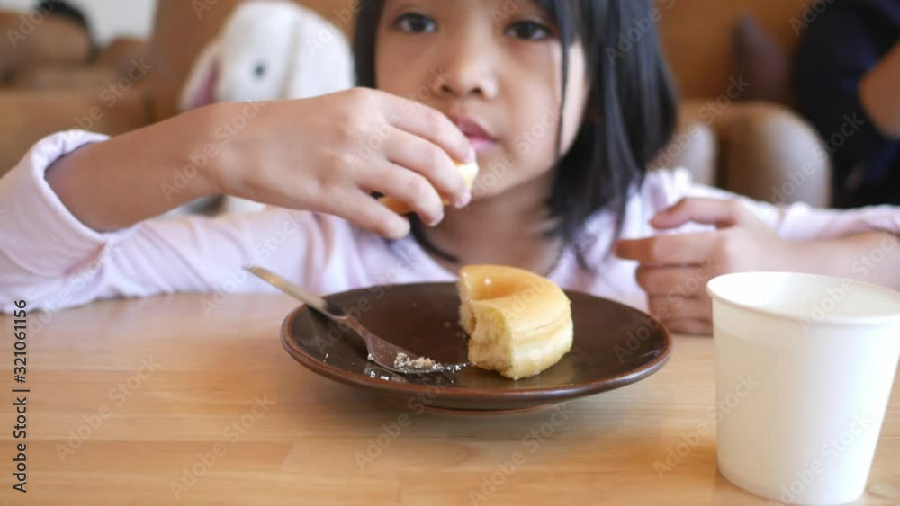 Asian girls feel delicious with donuts.