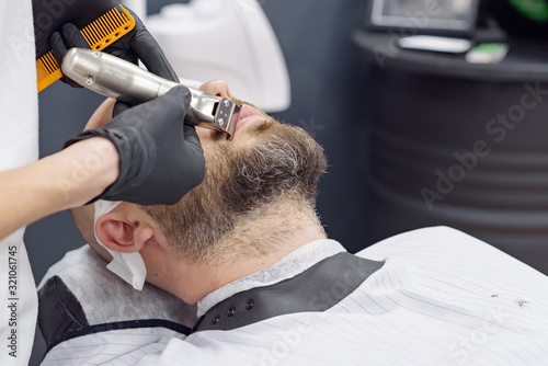 beard modeling in Barber shop, beard care for men, male beauty concept © klavdiyav