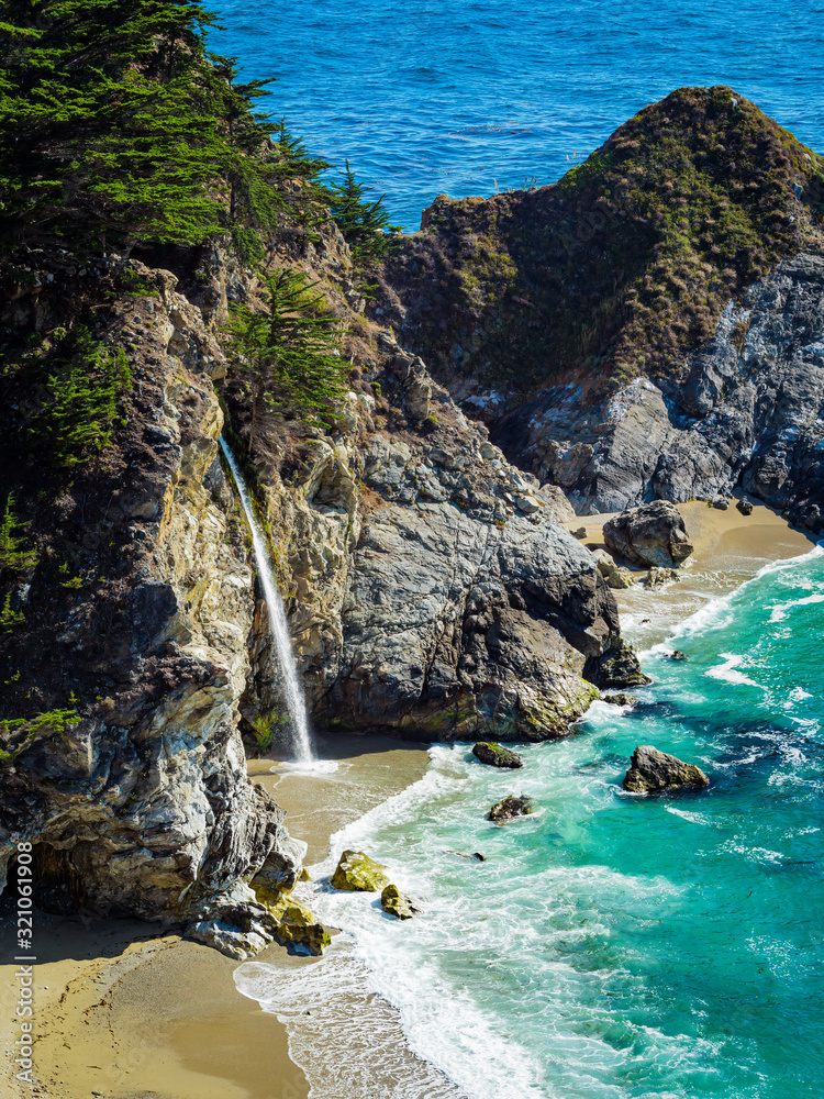 Fototapeta premium Aerial view of Water Fall McWay Falls Julia Pfeiffer Burns Park Big Sur California. McWay Falls a waterfall empties directly into the ocean.