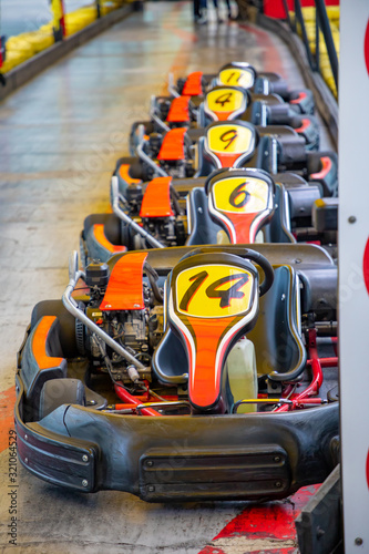 Row of carts with approval yellow numbers, ready to start inside a open track circuit