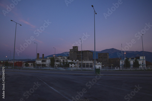 Old industrial area with a road in front of it.