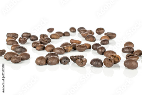 Lot of whole disordered fresh coffee bean isolated on white background
