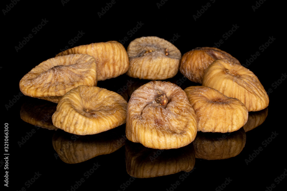Group of eight whole dried fig circle isolated on black glass Group of eight whole dried fig circle isolated on black glass