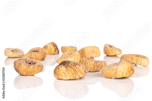 Lot of whole tan dried fig isolated on white background