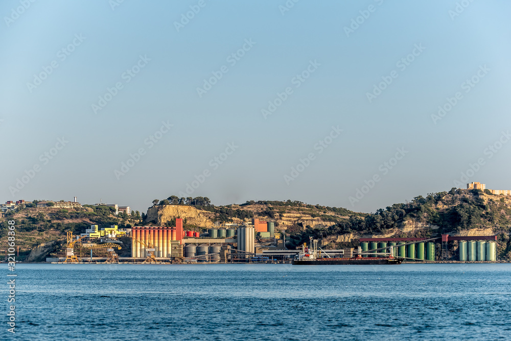 Colourful industrial shipping terminal on Tejo river in afternoon sun Colourful industrial shipping terminal on Tejo river in afternoon sun