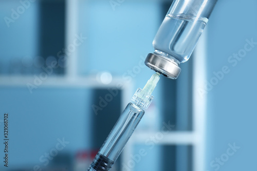 Syringe with filler for cosmetology and ampule, closeup