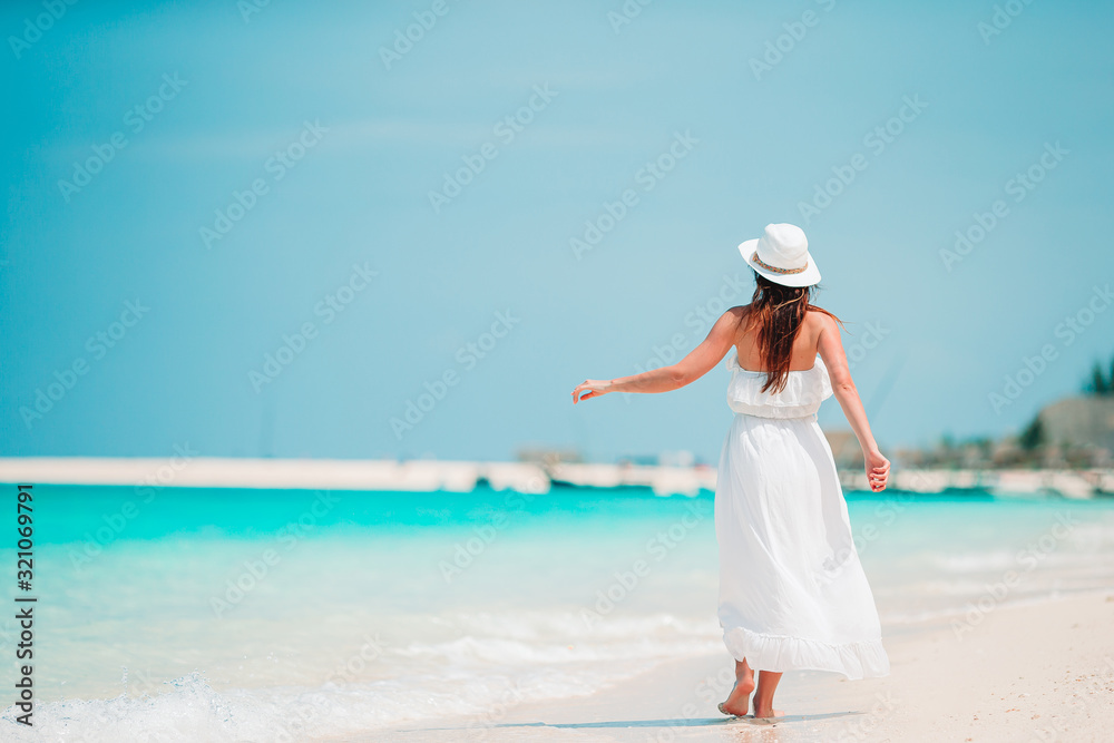 Young fashion woman in green dress on the beach Young fashion woman in green dress on the beach