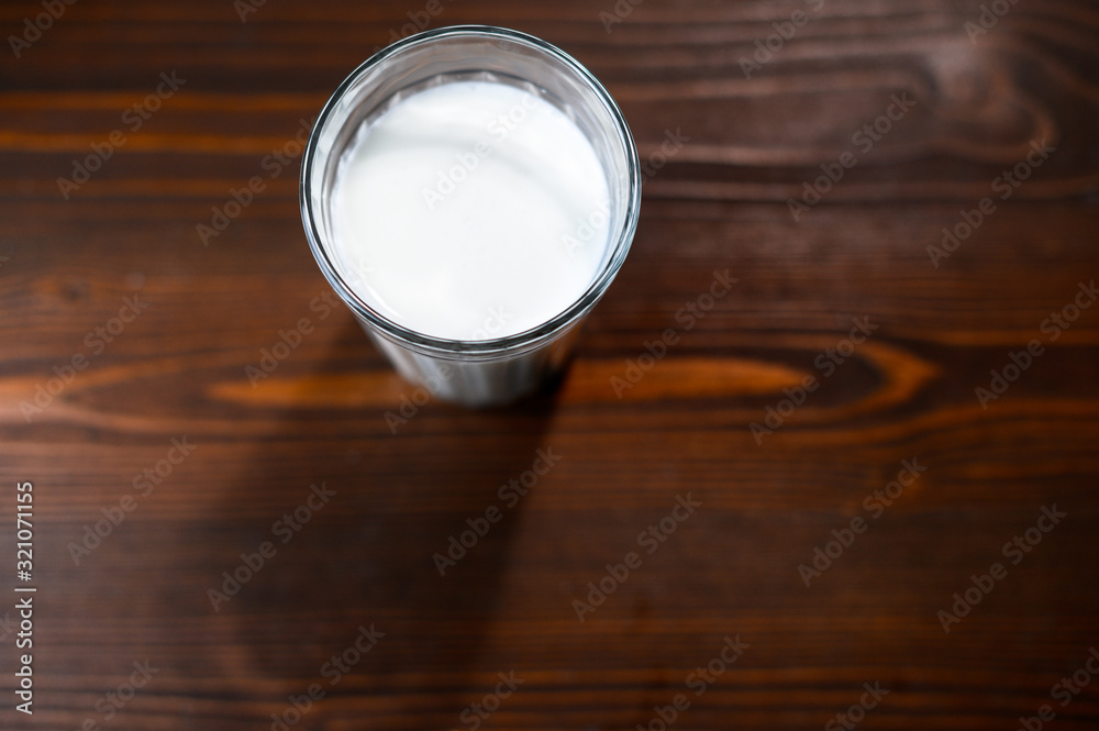 Glass of fresh cow's milk on a wooden table top view. Glass of fresh cow's milk on a wooden table top view.