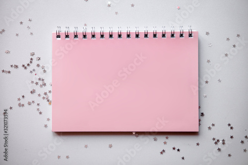 Planning concept notebook with festive decorations and place for text on white table. Flat lay style, pastel colours