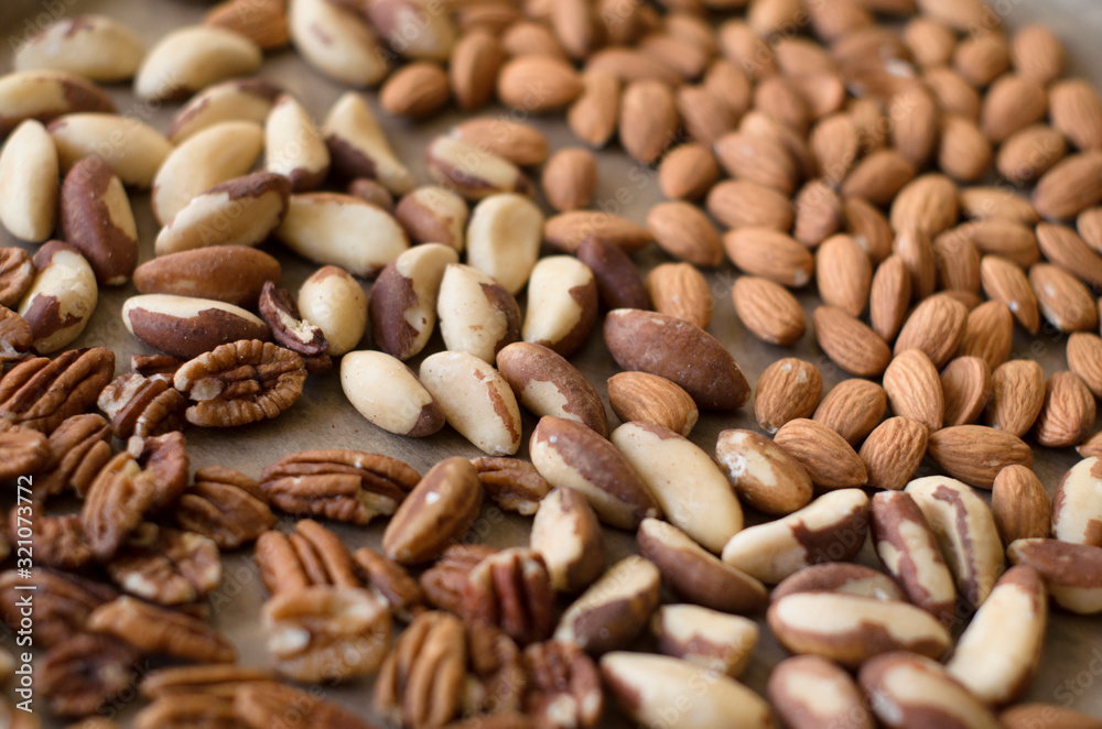 Background of mixed nuts - pecans, almonds, brasil nuts Background of mixed nuts - pecans, almonds, brasil nuts