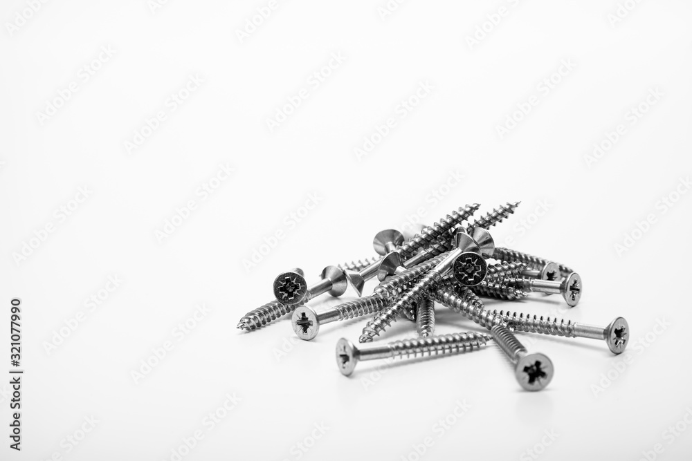 Pile of metal wood screws isolated on a white background with space for copy Pile of metal wood screws isolated on a white background with space for copy