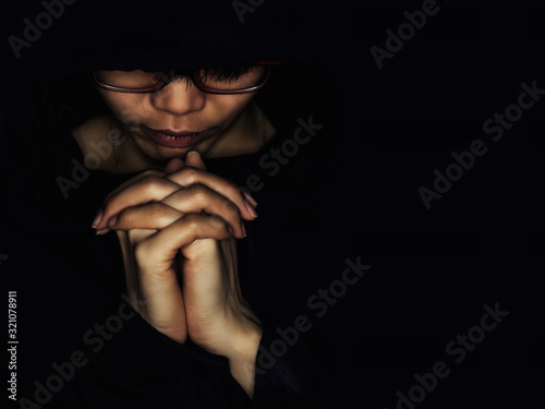 Fotografie Christian women pray for blessings with faith on a black background