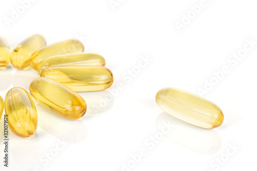 Lot of whole arranged golden fish oil isolated on white background